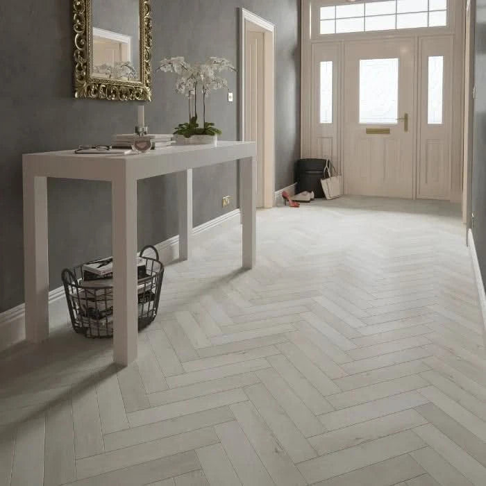 Завантажте зображення в засіб перегляду галереї, icelandic oak herringbone laminate flooring on display in a hallway