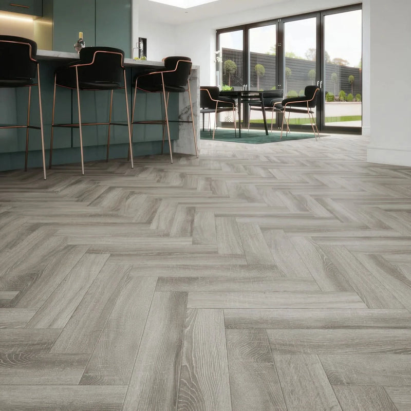 Завантажте зображення в засіб перегляду галереї, platinum grey herringbone laminate flooring displayed in a kitchen