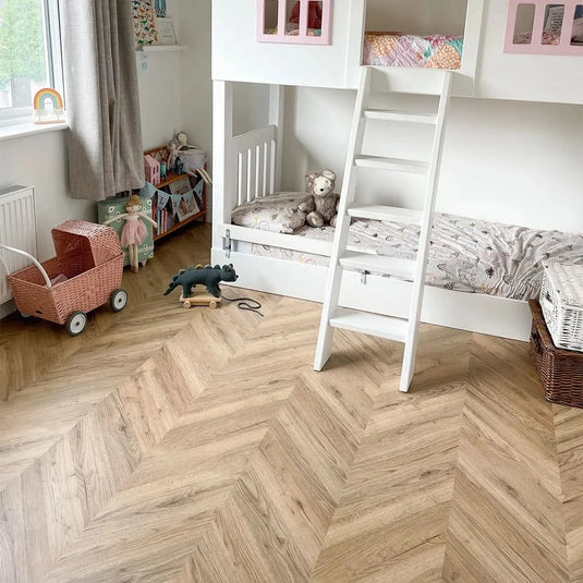 dark rillington oak laminate flooring on display in a bedroom in a chevron pattern