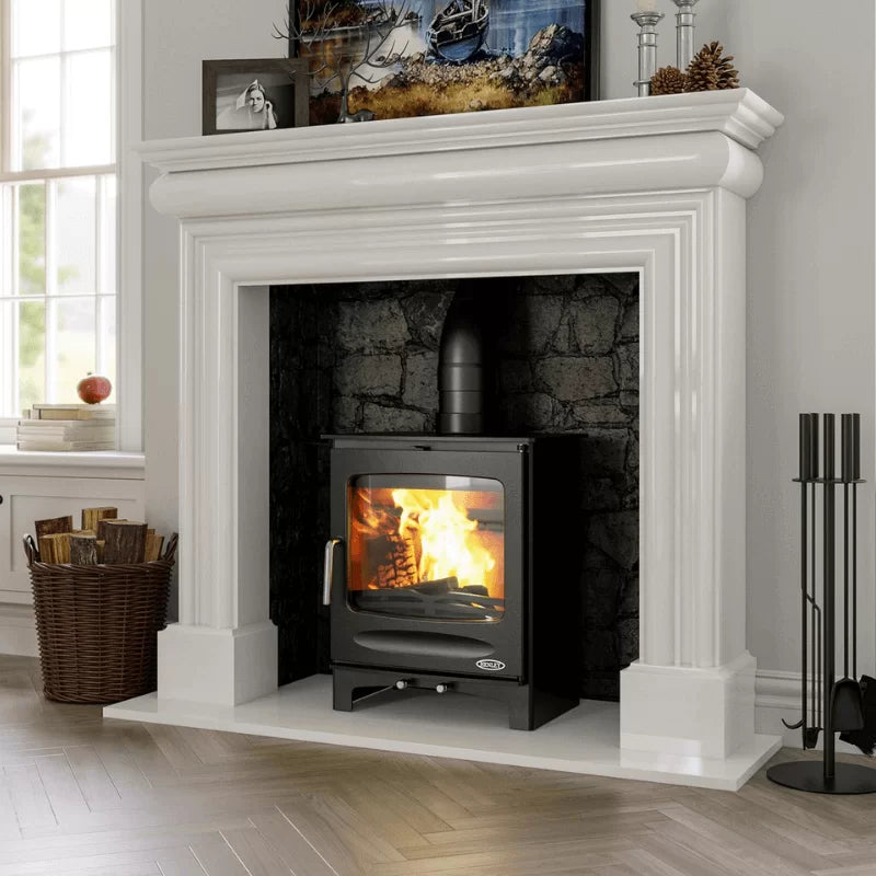 Load image into Gallery viewer, White fireplace with a lit stove, decorative items on the mantel, and a window in the background.