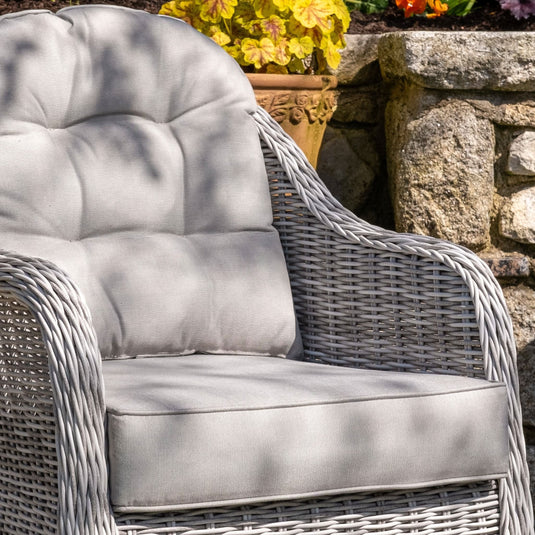 light grey curved armchair with light grey back and base cushions