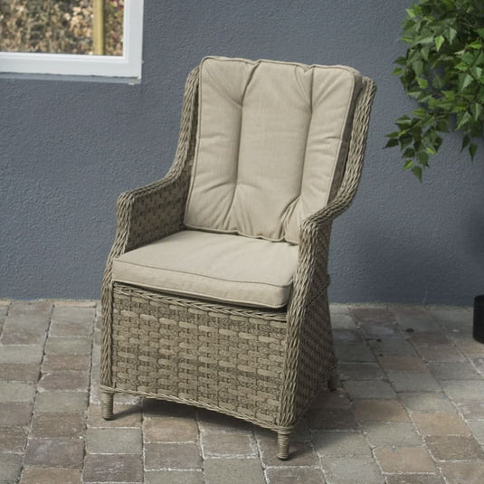 curved armchair in a natural colour with sand coloured back and base cushions