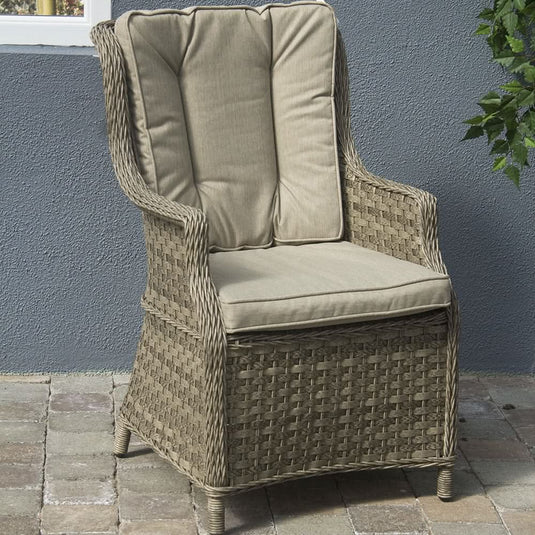 curved armchair in a natural colour with sand coloured back and base cushions