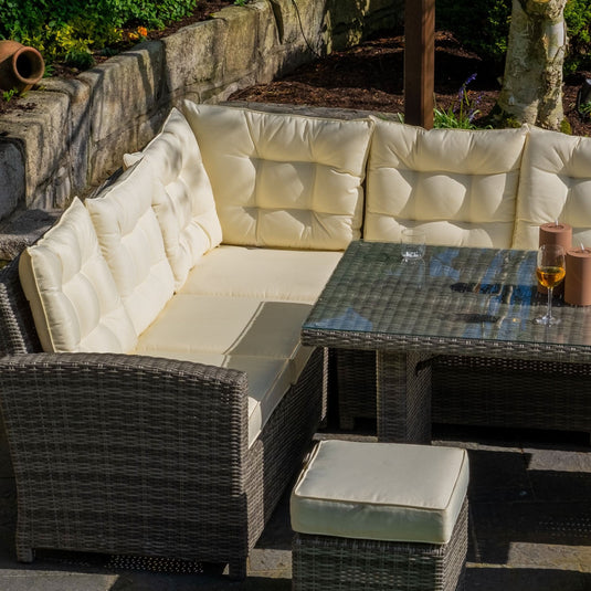 grey corner sofa set & cream cushions with glass topped rectangular table and 3 footstools