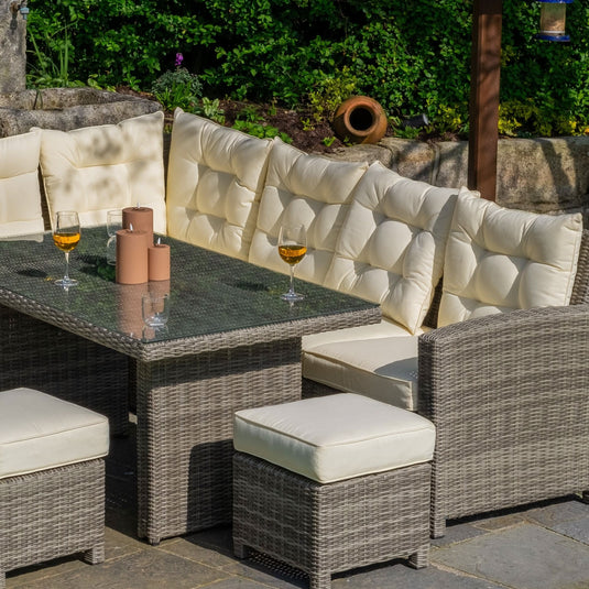 grey corner sofa set & cream cushions with glass topped rectangular table and 3 footstools