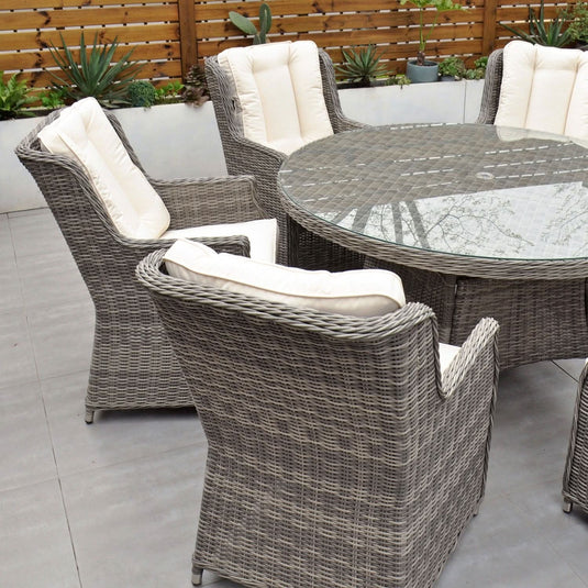 grey 6 seat set with 135cm glass topped round table and cream cushions