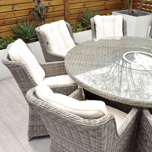grey 6 seat set with 135cm glass topped round table and cream cushions