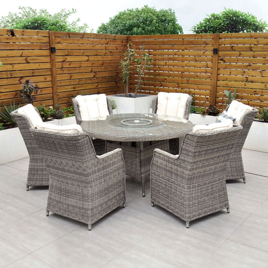 grey 6 seat set with 135cm glass topped round table and cream cushions